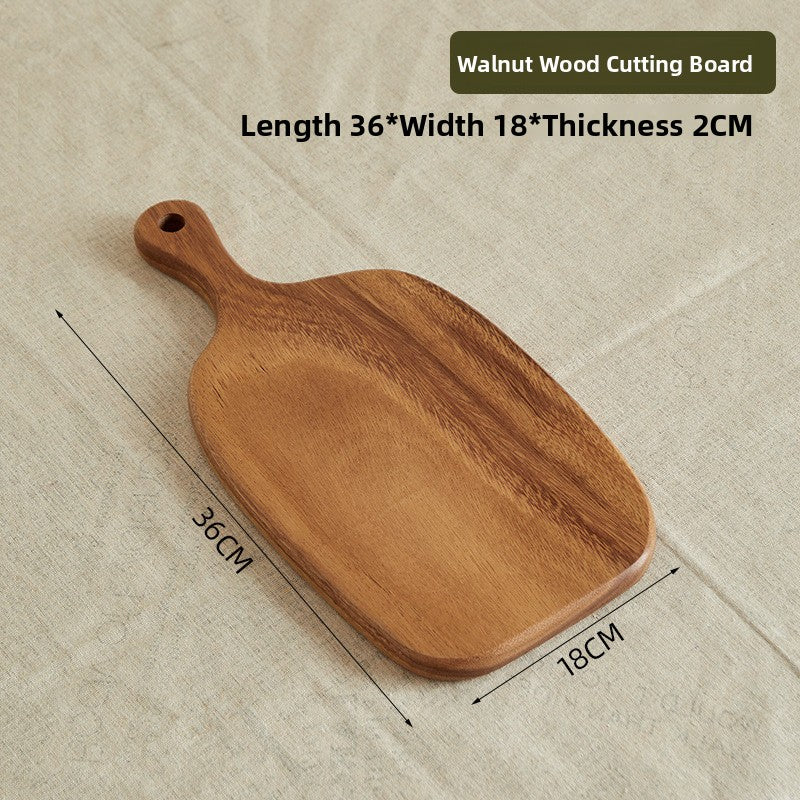 Walnut steak plate board with a shaped edge shown with grilled food