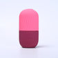 Pale yellow silicone facial ice tool upright, smooth rounded dome and grooved base
