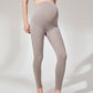 Front view of grey maternity leggings with a tall stretch panel worn over the belly