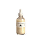 Clear glass dropper bottle of pale cream True Belly Serum body oil shown alone on a plain white studio backdrop