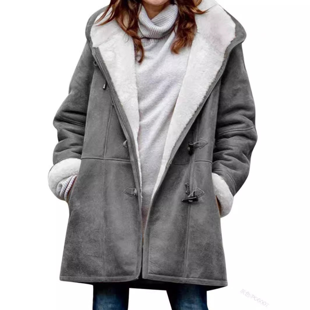 Model in an open gray hooded toggle coat showing the white plush lining, cuffs and side pockets