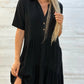 Red short sleeve cotton and linen tiered shirt dress worn by a model with a lapel collar and two button placket