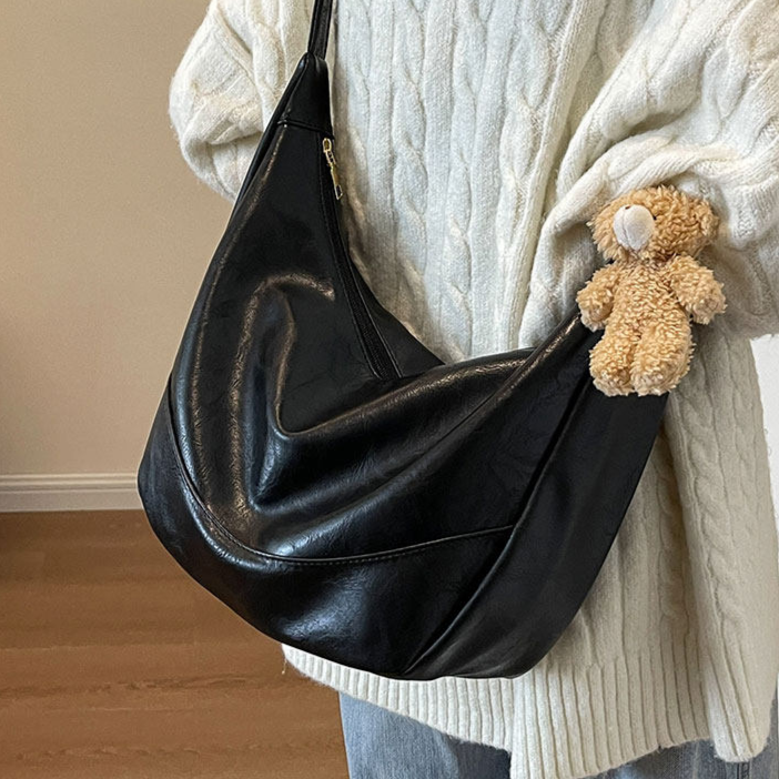 Crossbody dumpling bag adjustable strap and clip detail