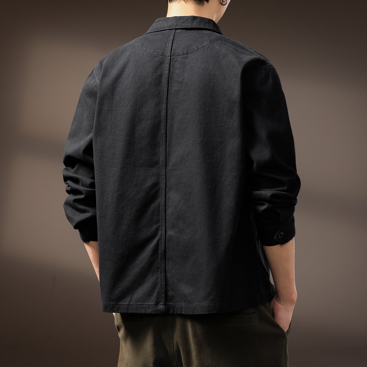 Workwear shirt jacket worn open over a plain tee, styled with denim for a layered casual look