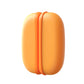 Orange magnetic hand warmer pair joined together on a white background, side view of the seam
