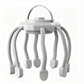 White scalp massager with a top carry loop, grey flexible claws and white massage pads