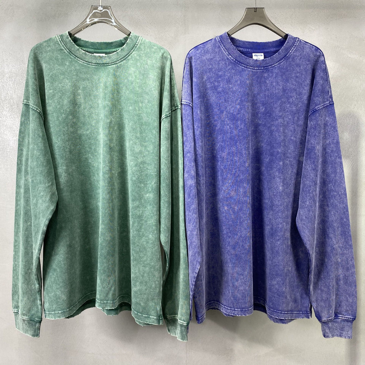 Washed heavyweight oversized long sleeve tee in dark blue hanging from the front