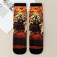 Pair of mid-calf socks with an orange sunset scene of a vampire among bats and bare trees