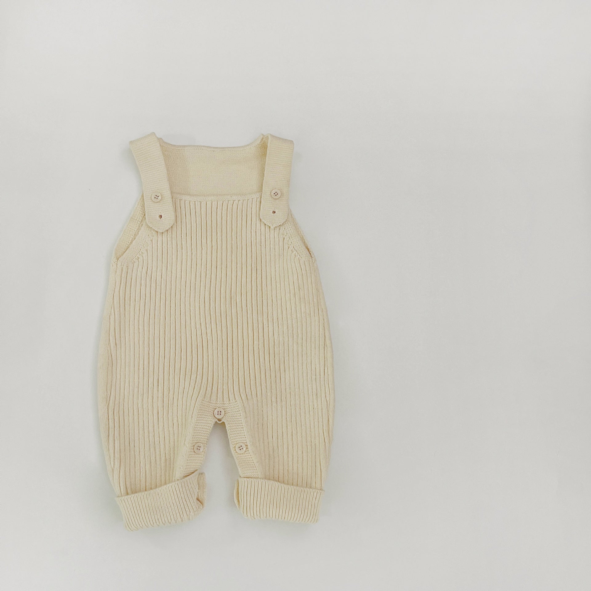 Third angle reference of the knit baby dungarees showing the full shape