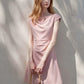 A-line cap sleeve ruched waist mini dress in soft stretch knit, back view of the round neck and flared skirt