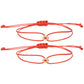 Two red cord bracelets with small gold tone charms and slide knots laid flat