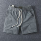 Grey men's cotton drawstring shorts framed close on the waist and flat cotton drawstring
