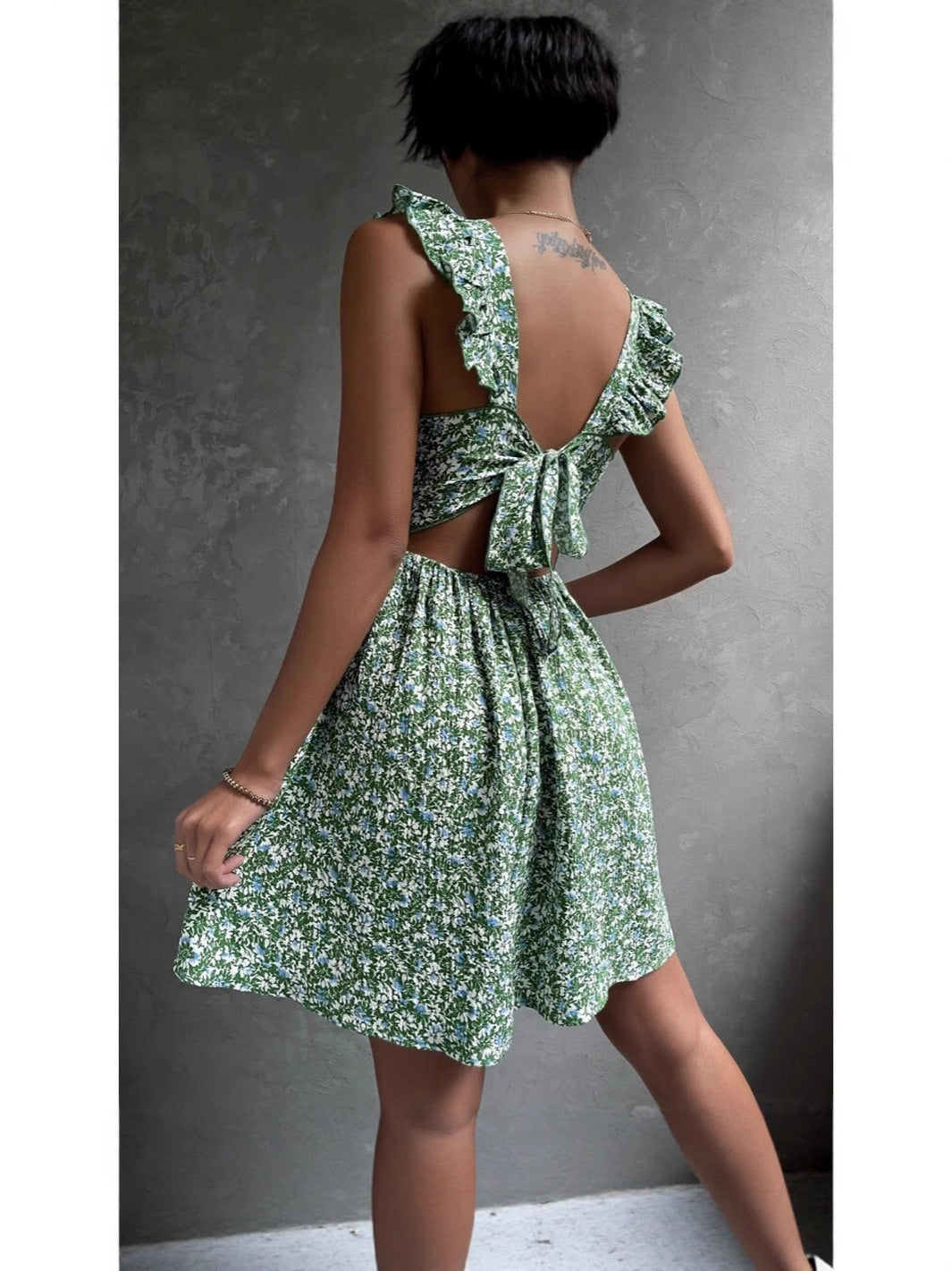 Floral square neck ruffle strap mini dress with a shirred bodice on a standing model, standing pose