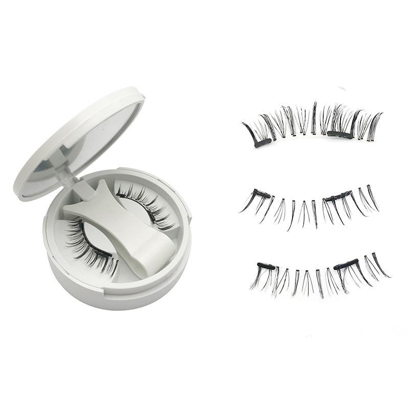 Round mirror compact open beside three natural style magnetic lash strips