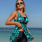 Green leaf print swimdress with flared skirt and black waist band, side angle