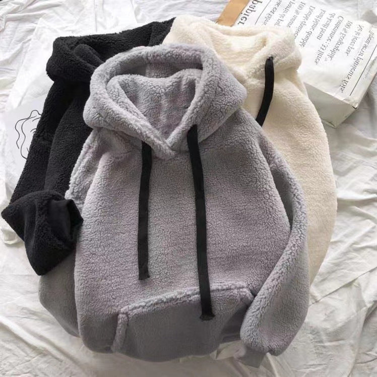 Detail of the soft sherpa pile on a black women's hooded sweatshirt
