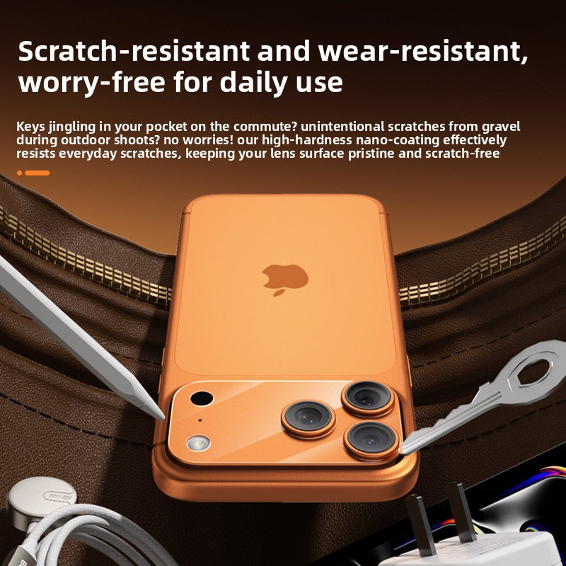 Orange lens protector fitted flush on an iPhone camera bump held in a hand