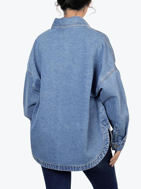 Back view of a washed blue denim shirt jacket with a yoke seam, dropped shoulders and a rounded hem with a side vent