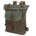 Retro canvas roll-top backpack in olive green with teal green flap, brown straps and buckle, three-quarter view