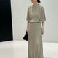 Greige long ribbed knit skirt styled with a knit top and black bag, front view, top not included