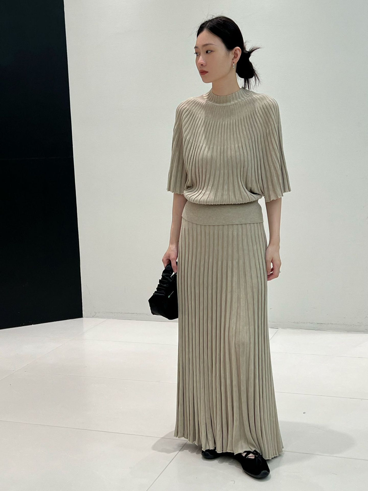 Greige long ribbed knit skirt styled with a knit top and black bag, front view, top not included
