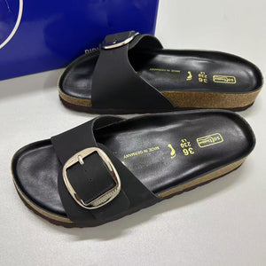 Women's retro flat sandals with large gold buckle front view