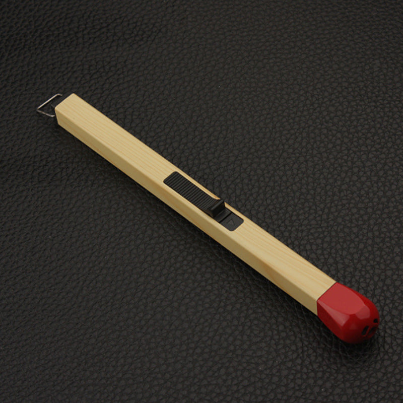 Close up of the red metal ignition tip of a long kitchen stove lighter