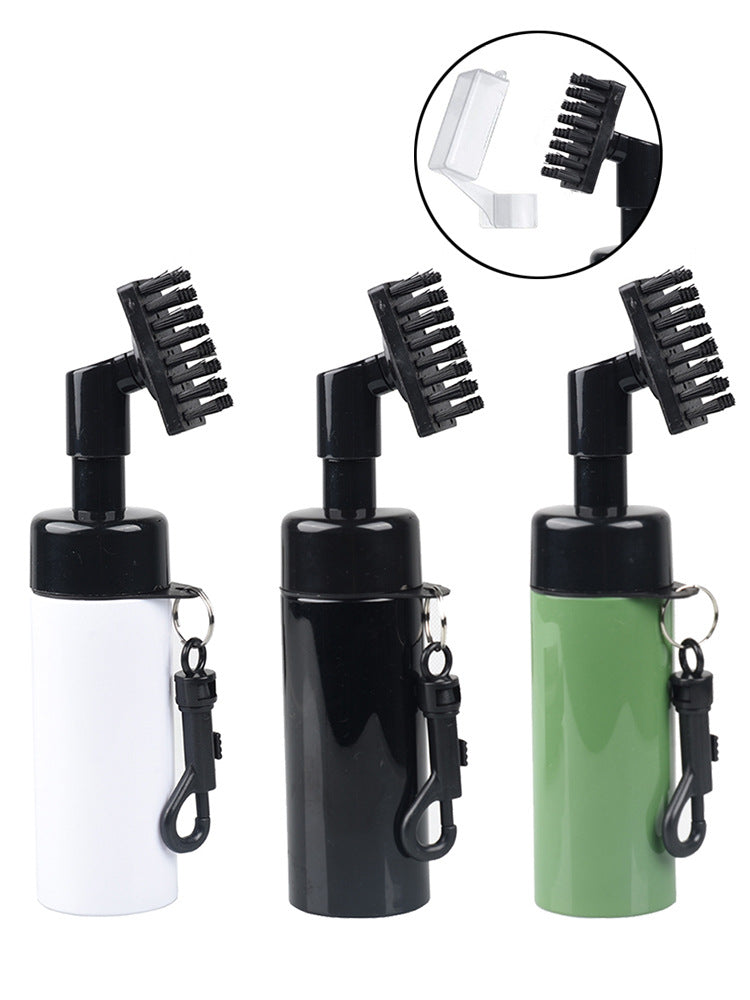 Golf club cleaning spray brush in white, black and green with a black brush head