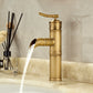 Antique copper bamboo basin faucet with an open waterfall spout pouring water on a stone counter