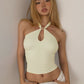Side profile of the fitted halter crop top showing the bare shoulder and back ties