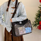 Boxy nylon shoulder bag with top handles, adjustable strap and see through front panel