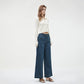 Retro flared jeans paired with loafers on a wooden floor