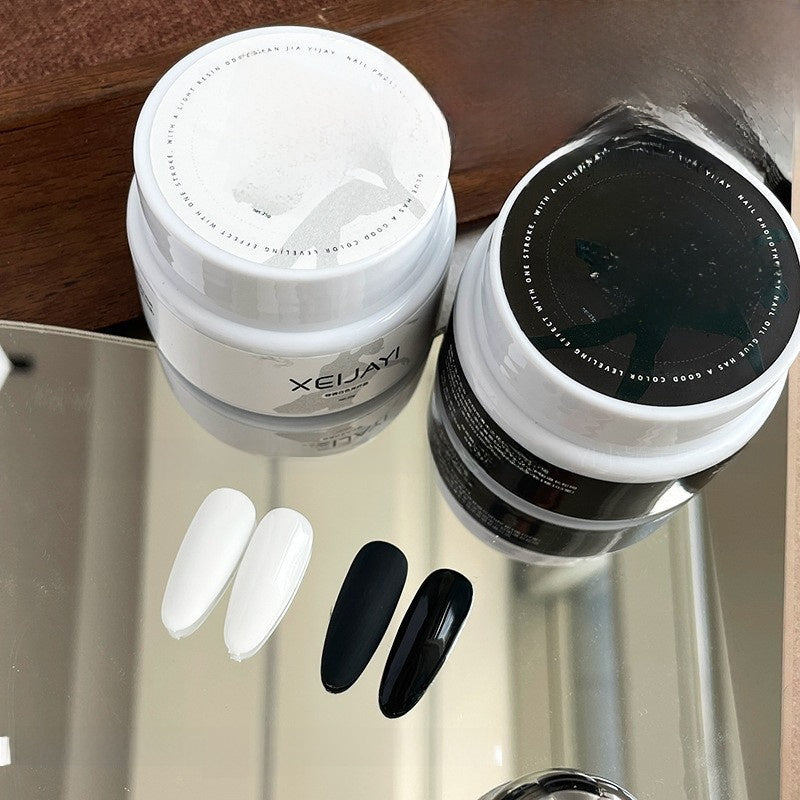 Black and white nail lacquer swatches side by side