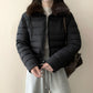 Side view of the cropped puffer jacket showing the quilted channels and short length