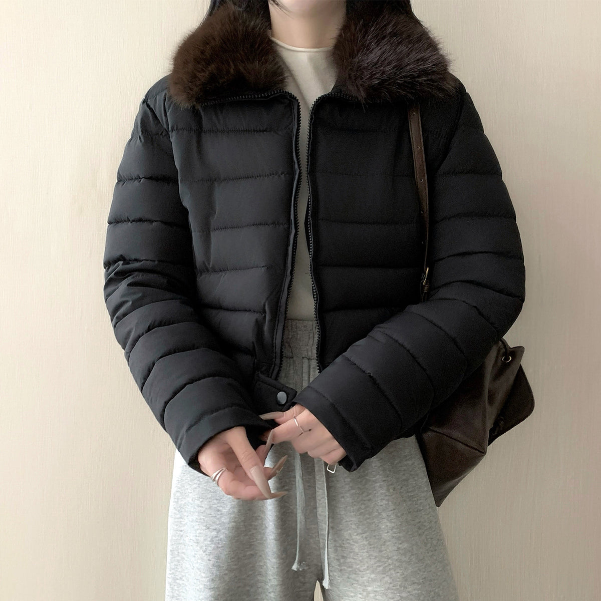 Side view of the cropped puffer jacket showing the quilted channels and short length