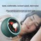 Emerald green watch winder turning a wristwatch on a nightstand beside a sleeping person
