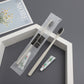 Beige straw toothbrush, toothpaste tube and a frosted dental kit pouch on a gray surface