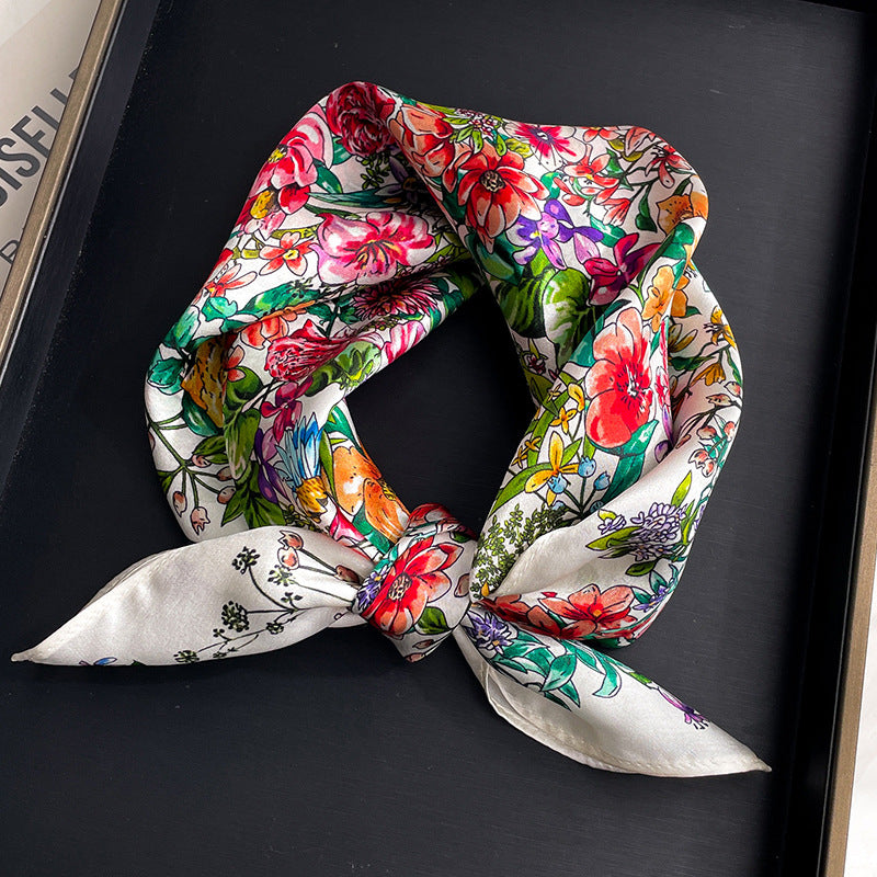 Bright multicolor floral printed square scarf with a satin sheen and hemmed edges, shown displayed