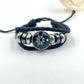 Black and pink braided cord bracelets shown side by side on a soft surface