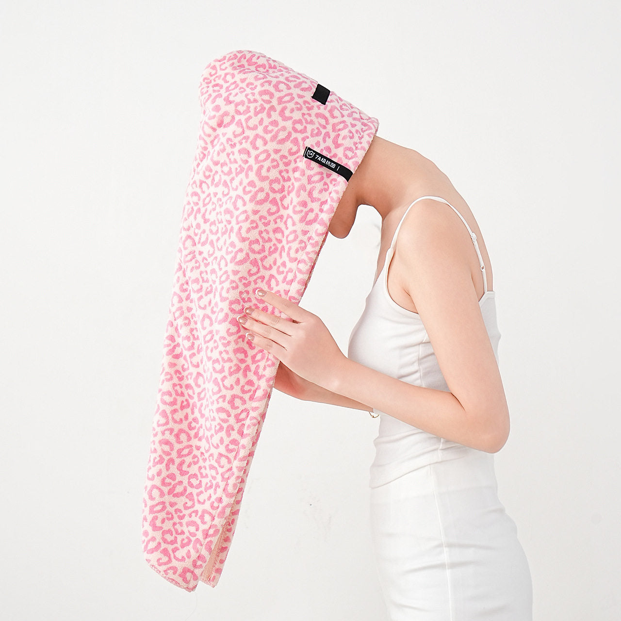 Top down view of the microfiber towel hair wrap laid flat on a surface