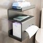 Grey wall mounted tissue shelf holding a phone and a pack of wet wipes above a toilet roll