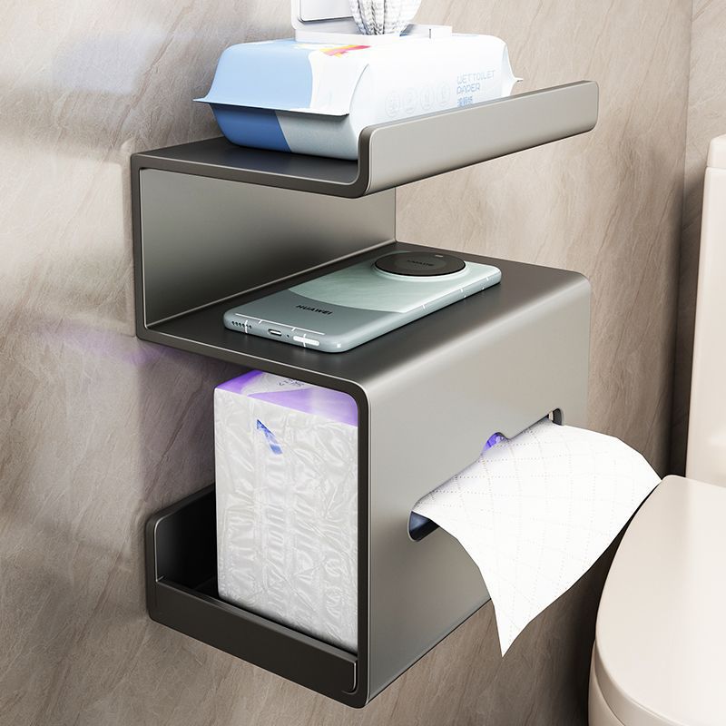 Grey wall mounted tissue shelf holding a phone and a pack of wet wipes above a toilet roll