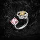 Cushion cut pink stone paired with a gold toned butterfly motif in clear pave, dark background