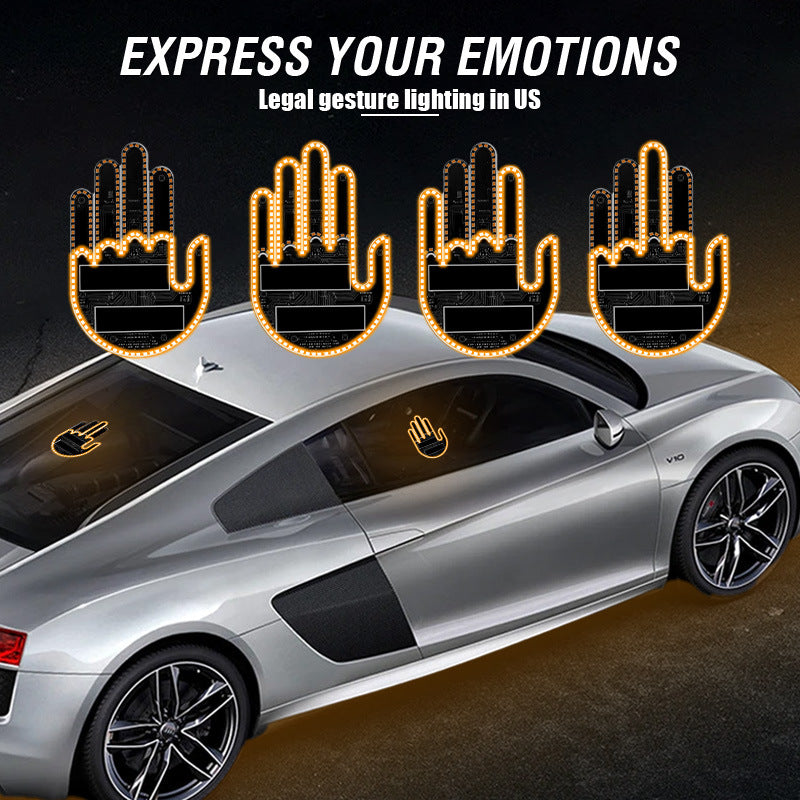 Four lit amber hand-shaped LED lights above a silver car with hand lights visible on its windows