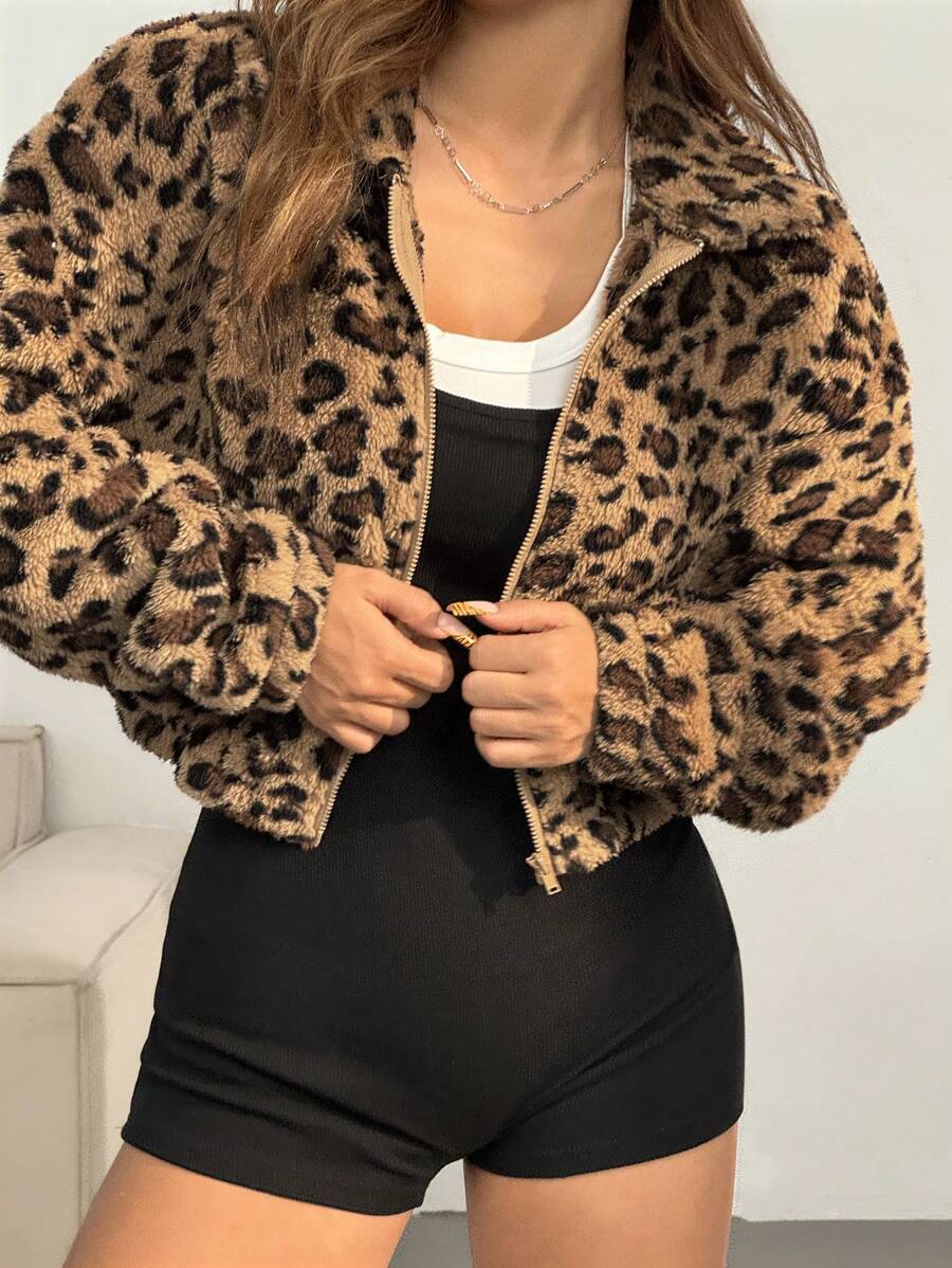 Womens cropped leopard vegan fur zip jacket styled over a black bodysuit in a studio