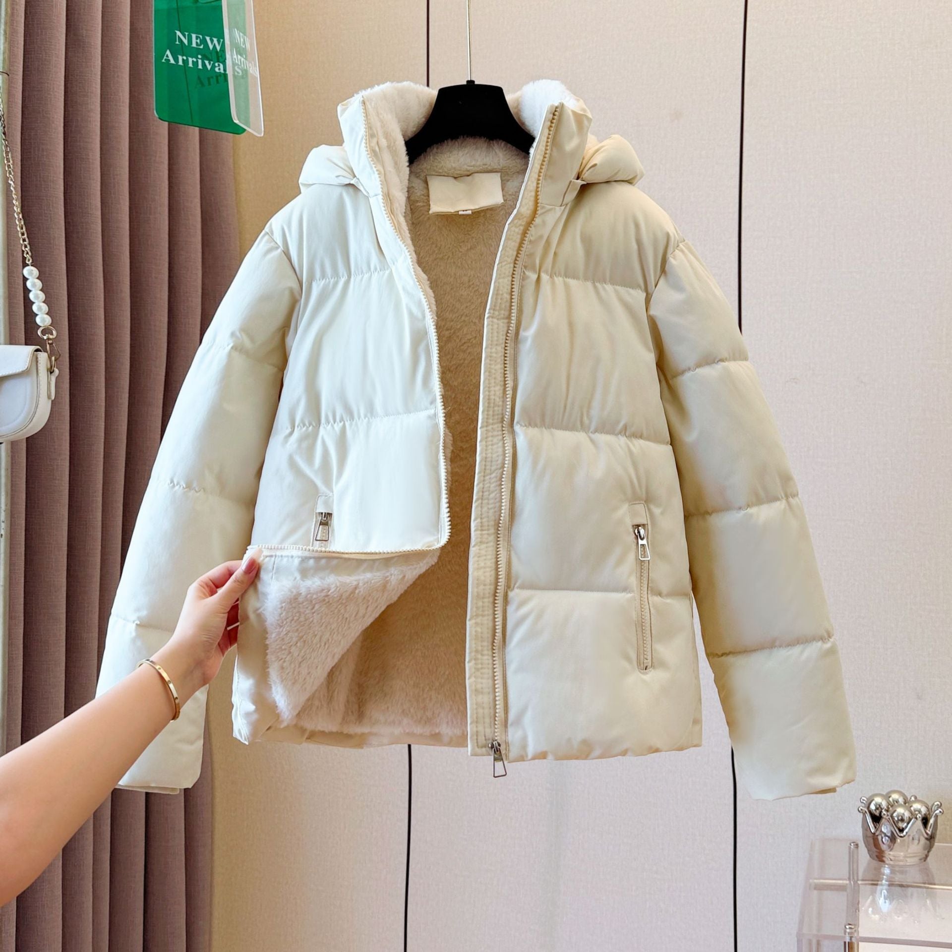 Hooded puffer shown open to reveal the plush fleece lining through the body and hood