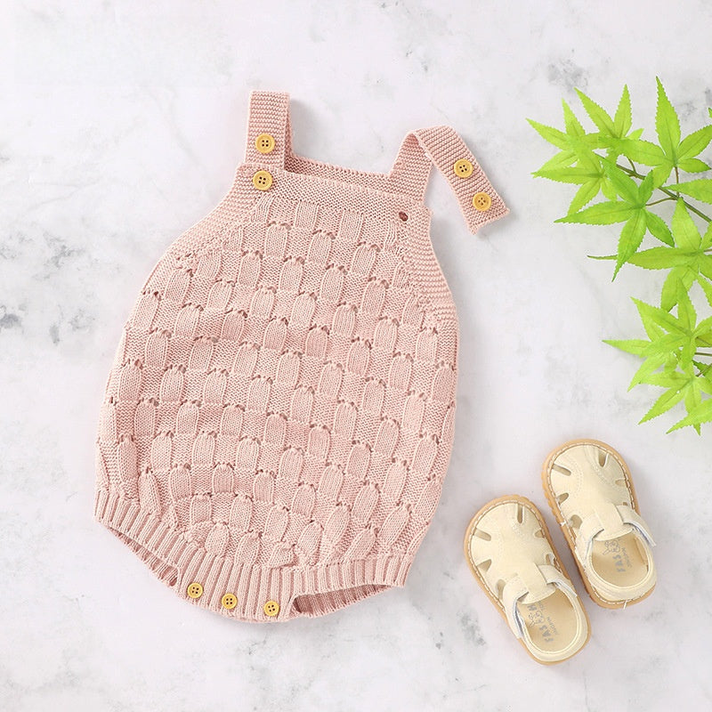Pink knit baby romper flat from above showing the full sleeveless one-piece shape