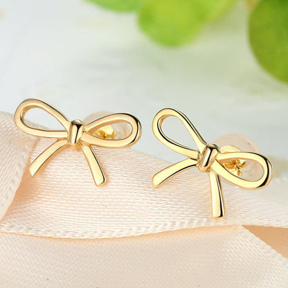 18K Gold Bow Earrings for Women | on a clean studio background
