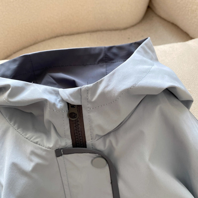 Close up of the hood, zipper and snap placket flap on the light blue boys hooded jacket