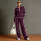 Purple half zip sweatshirt and wide leg pants set with white piping, worn full length